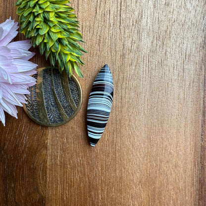 Fordite Cabochon - approx. 27 x 7 x 3.8 mm